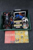 A box of remote control car, die cast vehicles, Cluedo board game,