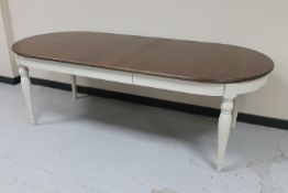 An oval dining table on painted base