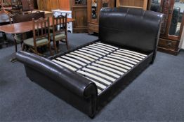 A leather 4' 6" bed frame