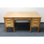 A 20th century oak twin pedestal writing desk