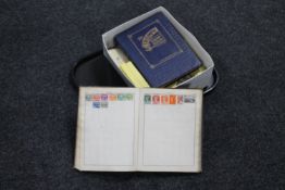 A tray of two 20th century stamp albums containing stamps of the world,