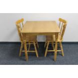 A rubber wood kitchen table together with two chairs
