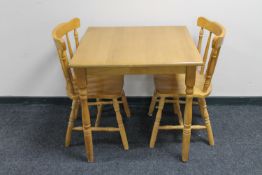 A rubber wood kitchen table together with two chairs
