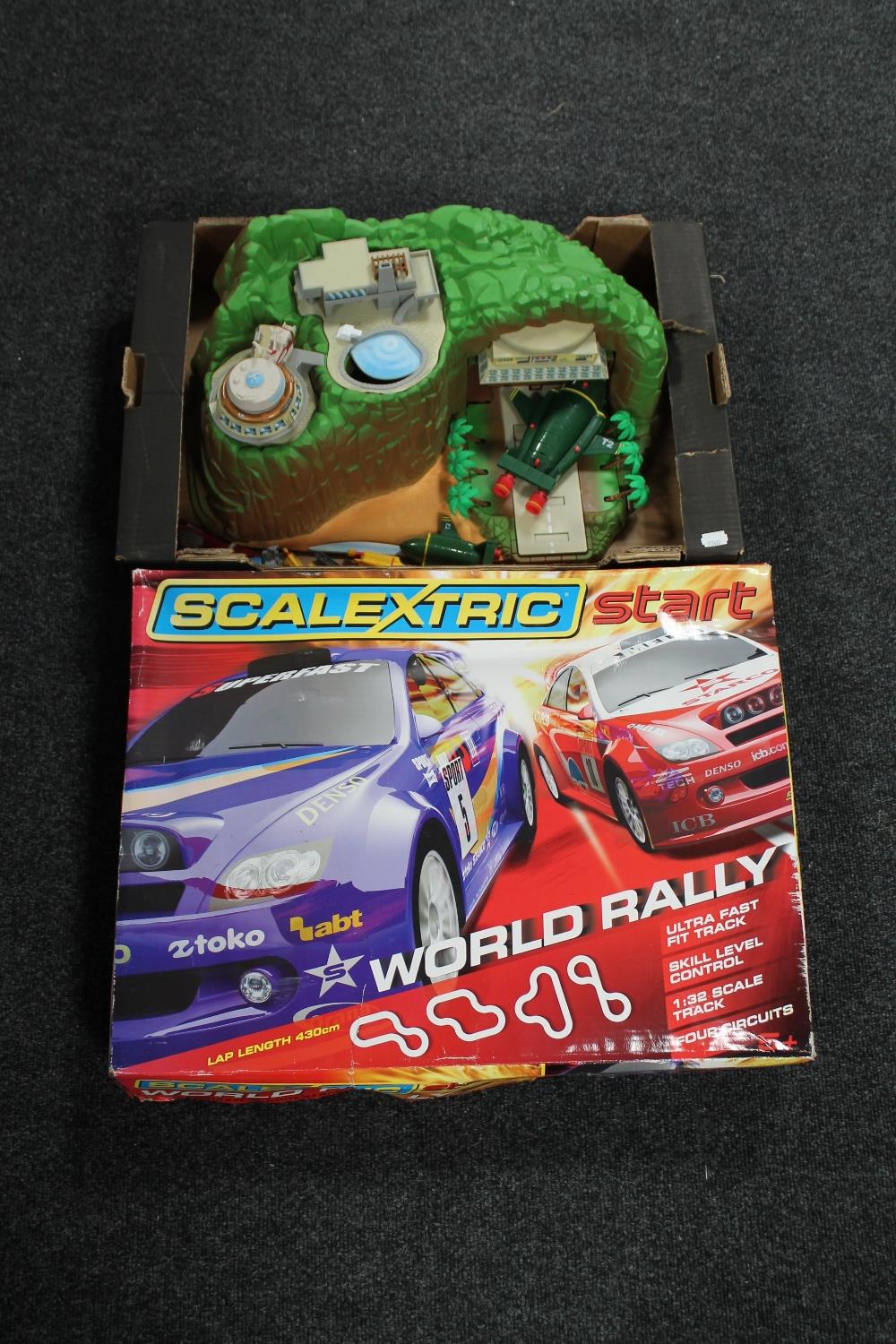 A boxed Scalextric World Rally together with a further box containing a Thunderbirds Tracy Island