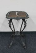 An ornate continental wrought iron plant stand
