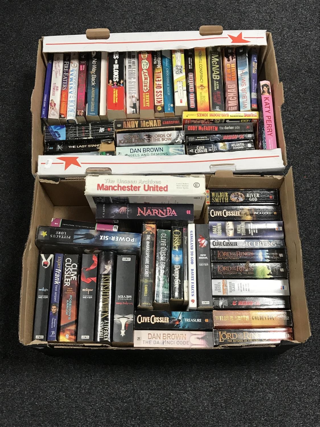 Two boxes containing paperback books, novels,