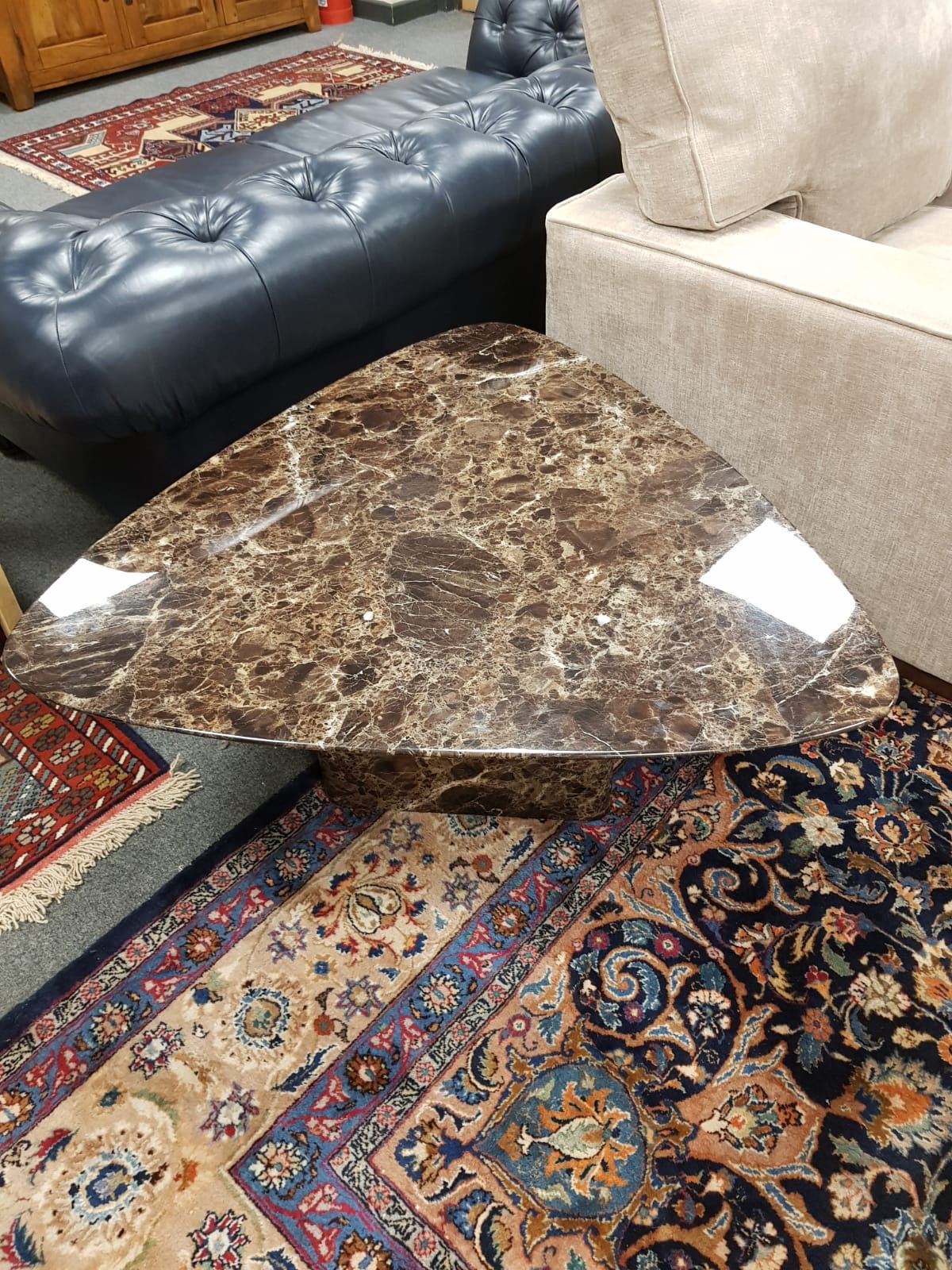 A contemporary marble triangular low table,