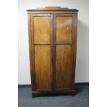 A 1930's oak double door gent's wardrobe
