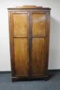 A 1930's oak double door gent's wardrobe