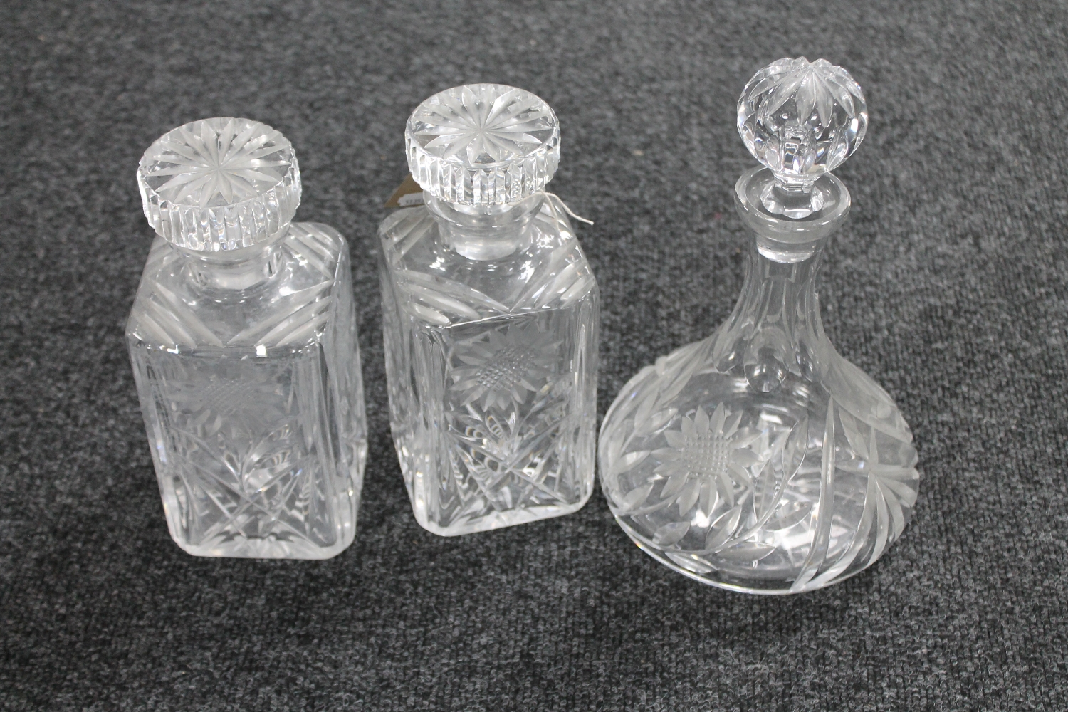 Two lead crystal whisky decanters together with one other decanter
