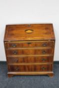 A Victorian style inlaid walnut bureau