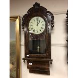 A Victorian walnut eight day wall clock with enamelled dial