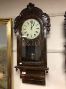 A Victorian walnut eight day wall clock with enamelled dial