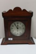 A brass ship's clock contained within a mahogany mantle type case.