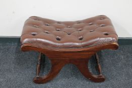 A mahogany Chesterfield style brown button leather upholstered footstool