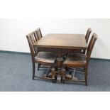 A 1930's oak pull out dining table together with four chairs,
