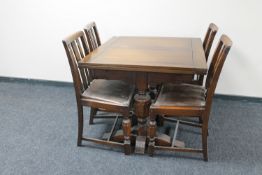 A 1930's oak pull out dining table together with four chairs,