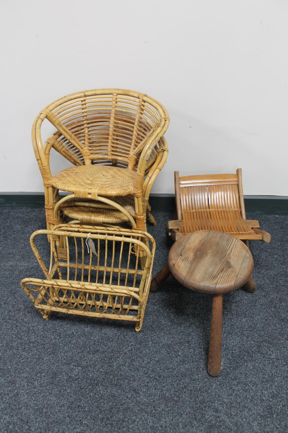A 20th century bamboo magazine rack together with a pair of similar child's chairs,