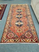 A Khamseh rug 277 cm x 127 cm