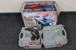 A cased drill together with a boxed Clark woodworker 8" table saw