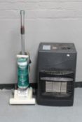 A Hoover upright vacuum together with a gas heater
