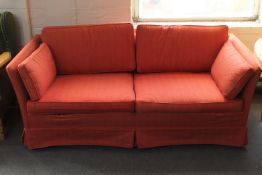 A two seater settee upholstered in red fabric