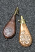 A copper and brass embossed powder flask together with a tooled leather powder flask