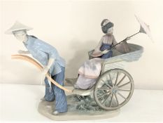 A Lladro figure of a lady in Chinese dress on a rickshaw CONDITION REPORT: Geisha