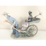 A Lladro figure of a lady in Chinese dress on a rickshaw CONDITION REPORT: Geisha