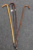 A good collection of walking sticks and an African staff to include one with silver mount.