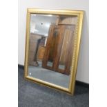 A gilt framed bevelled overmantel mirror