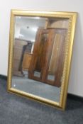 A gilt framed bevelled overmantel mirror