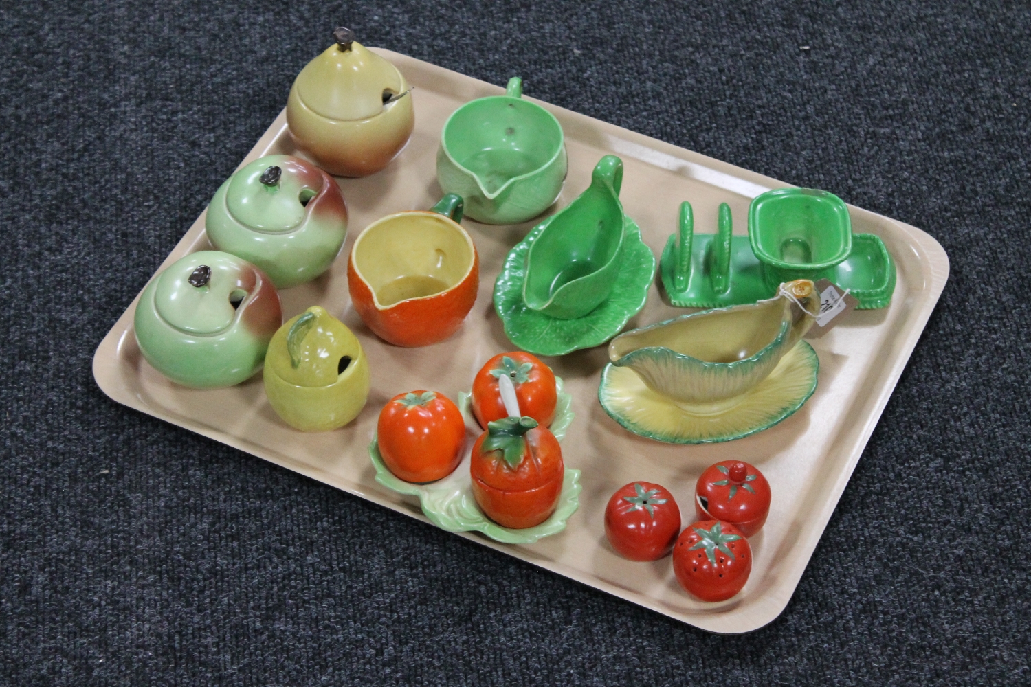 A tray of two three-piece tomato pottery cruet sets together with nine pieces of Carlton ware and