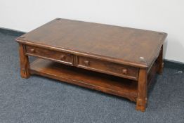 A stained two tier coffee table fitted two drawers