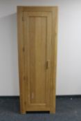 A contemporary oak single door wardrobe