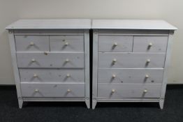 A pair of painted pine five drawer chests
