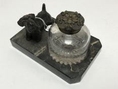 A late Victorian glass inkwell surmounted by a figure of a Scottie Dog mounted on a marble plinth,