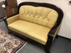 A Continental mahogany framed hall settee in golden buttoned fabric,