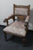 A Victorian oak armchair upholstered in floral fabric