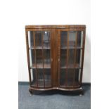 A shaped mahogany double door display cabinet