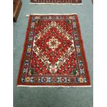 A Iranian rug of geometric design 142 cm x 102 cm