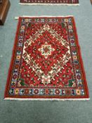 A Iranian rug of geometric design 142 cm x 102 cm