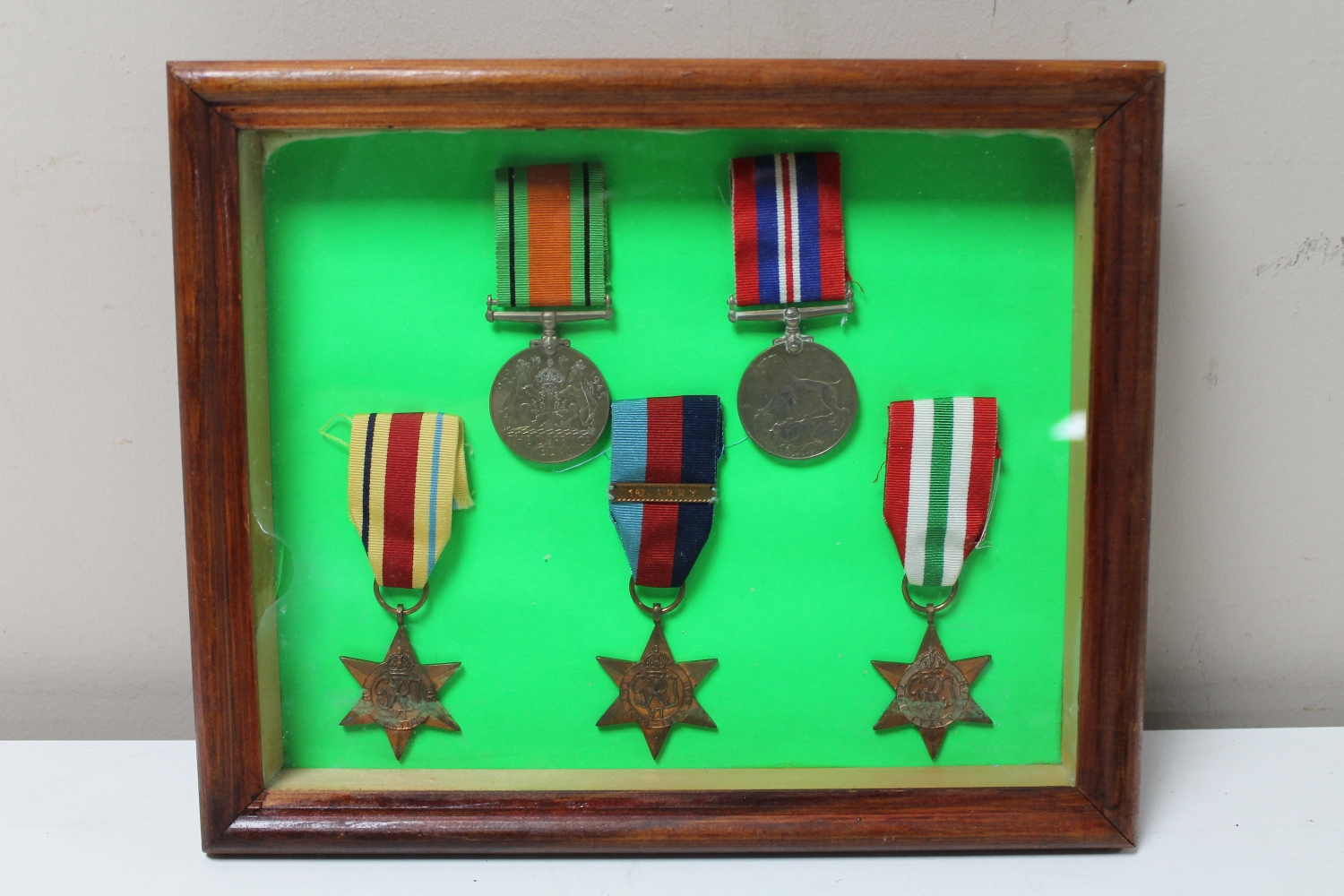 A set of five framed WWII medals with ribbons to include War Medal, Defence Medal, Italy Star,