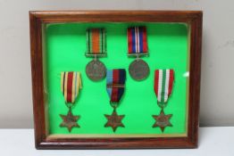 A set of five framed WWII medals with ribbons to include War Medal, Defence Medal, Italy Star,