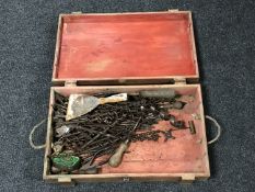 A wooden wine box containing a quantity of vintage drill bits