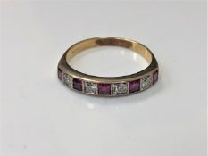 An 18ct gold ruby and diamond half eternity ring
