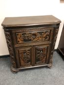 An Oriental carved rosewood cocktail cabinet,