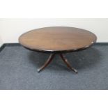 An inlaid mahogany oval coffee table