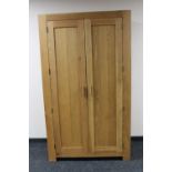 A contemporary oak double door wardrobe
