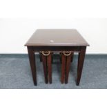 A mahogany lamp table fitted two tables beneath